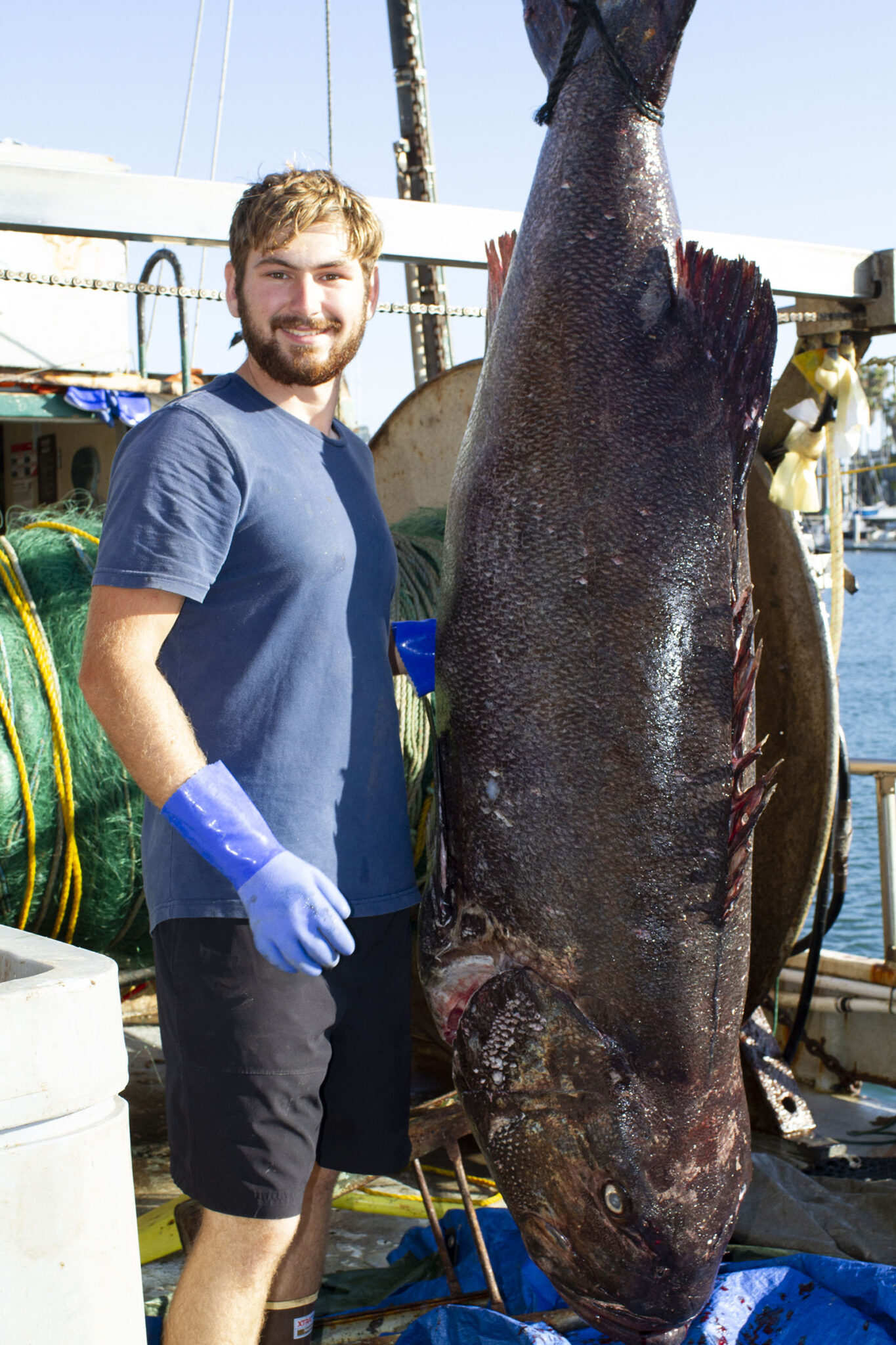 Commercial fisherman Chris Williams beside a freshly landed fish